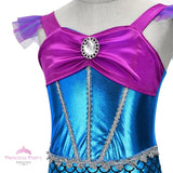 Girl's Little Mermaid style costume with shiny blue scale-print skirt, purple cap sleeves, and flared purple tulle tail fin bodice