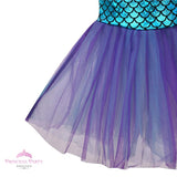 Girl's Little Mermaid style costume with shiny blue scale-print skirt, purple cap sleeves, and flared purple tulle tail fin close up