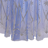 close up view of bottom of skirt of A Frozen-inspired long-sleeved princess dress with a gradient white-to-blue bodice and a flowing blue tulle skirt adorned with sparkling silver snowflakes and stars, perfect for a child's fantasy dress-up or themed party.