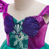 front detail view Little Mermaid-inspired special occasion dress for girls in purple and teal with seashell details, flowing tulle skirt, and optional tiara and magic wand accessories. Perfect for birthdays, costume parties, and dress-up play.