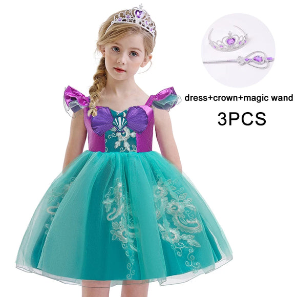 Little Mermaid-inspired special occasion dress for girls in purple and teal with seashell details, flowing tulle skirt, and optional tiara and magic wand accessories. Perfect for birthdays, costume parties, and dress-up play.